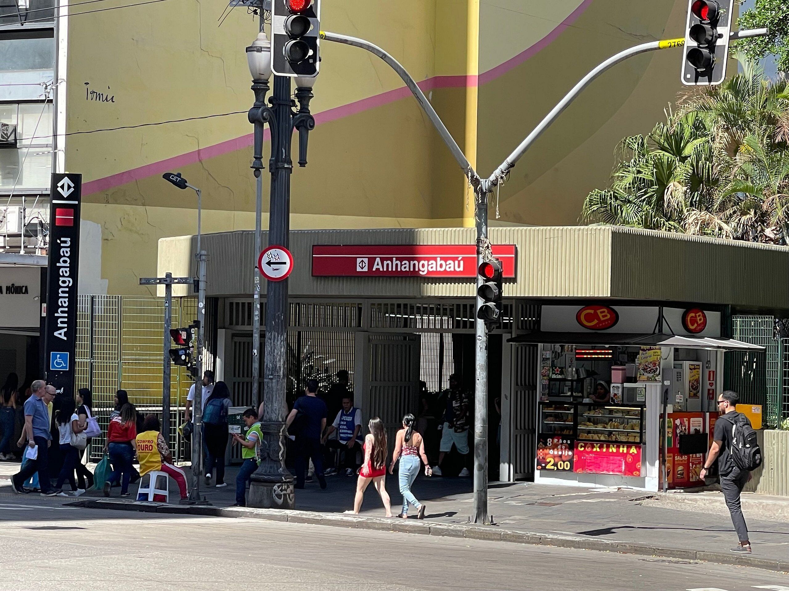 A street scene with a traffic light, pedestrians, and a building with a CB logo.