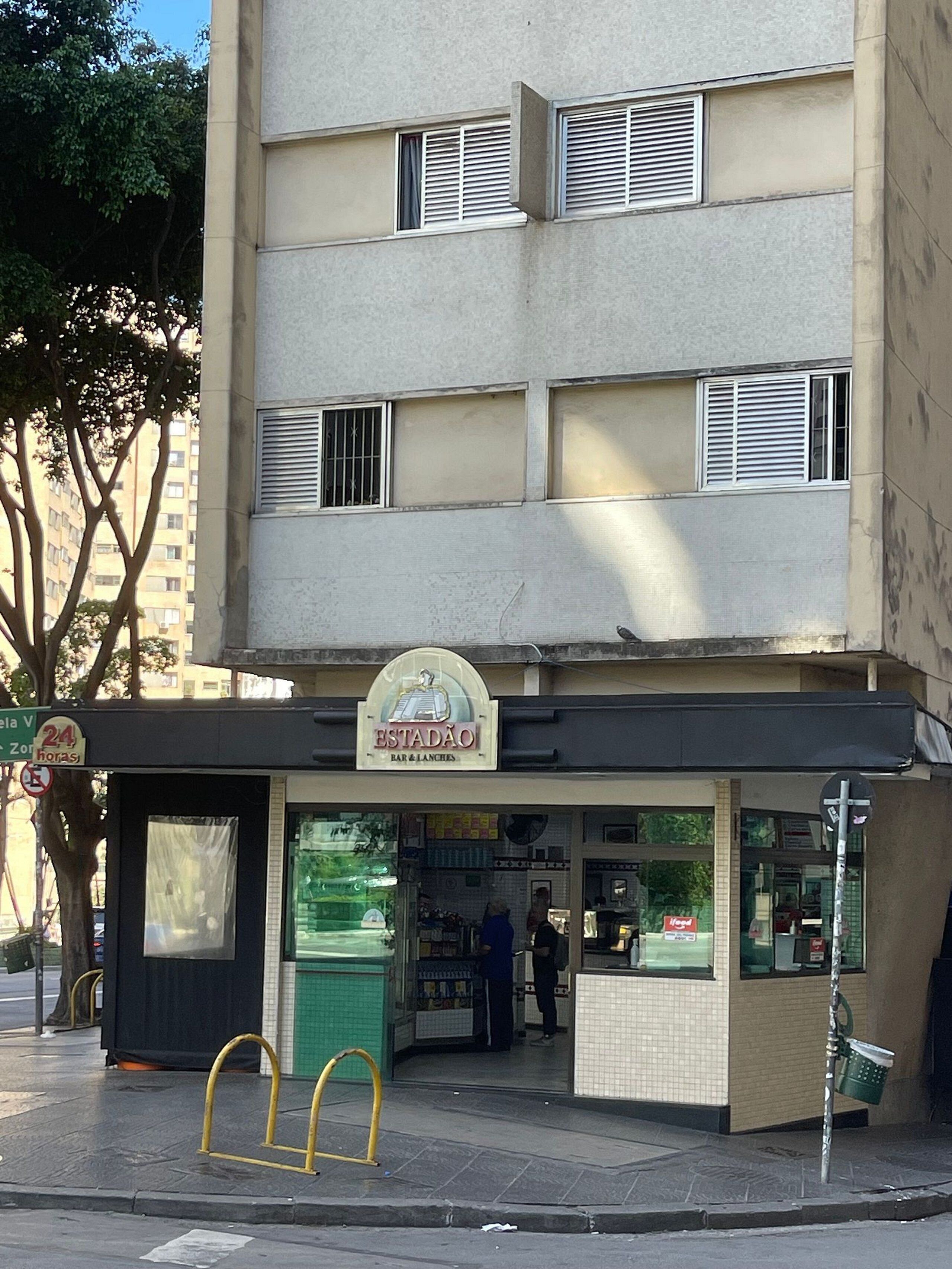 A two-story building with a bar and lunch establishment on the ground floor.