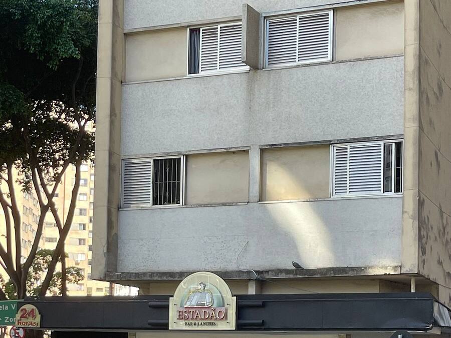 A two-story building with a bar and lunch establishment on the ground floor.