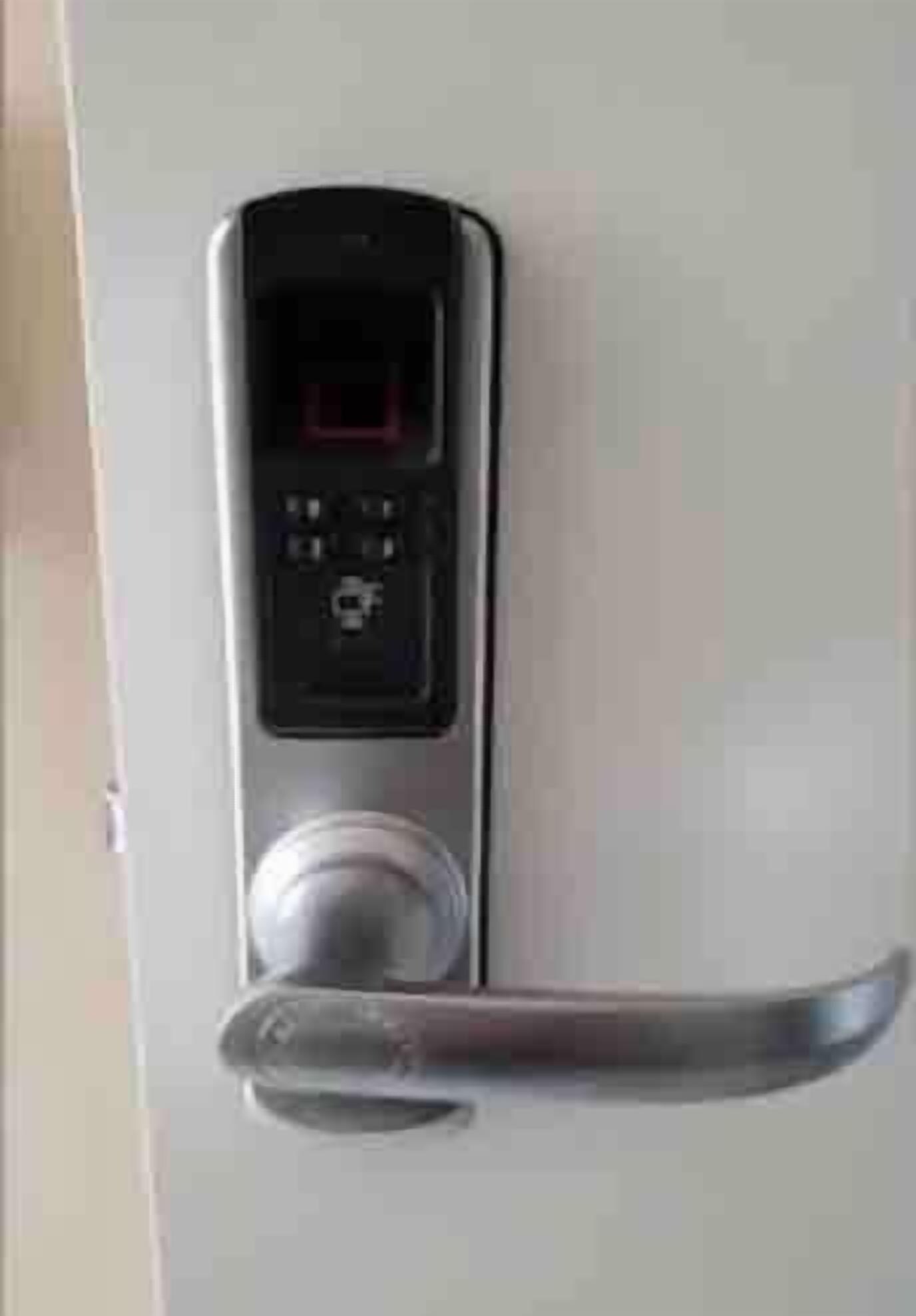 A door with a digital lock and a keyhole.