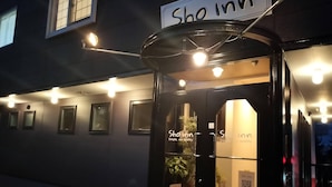 A hotel entrance with a sign reading "Sho inn" and a QR code on the door. - Sho inn MINIMAL HOTEL (Otaru)