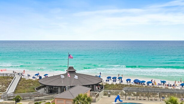 A beachside hotel with a boardwalk, beach umbrellas, and a pool area. - Sunrise gulf view/beach front condo! Enjoy one free beach chair set up each day (Destin)