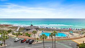 A resort with a swimming pool, beach access, and a parking area. - Sunrise gulf view/beach front condo! Enjoy one free beach chair set up each day (Destin)