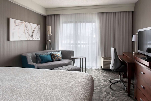 Relax on the cozy sofa beside soft daylight and calm views.