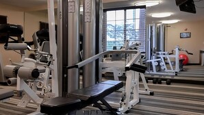 A gym with various exercise machines, a mirror, and a window with a view of snow-capped mountains. - Unwind in Clearwater! Full Kitchen, Outdoor Pool, Free Parking, Pets Friendly (Clearwater)