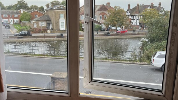 A room with a view of a canal, a wooden chair, and a radiator. - South London Single Bedroom in Mitcham (Mitcham)