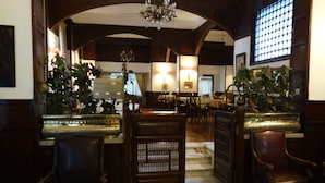 A hotel lobby with a reception desk, seating area, and staircase leading to upper floors. - Carlton Downtown Cairo (Cairo)
