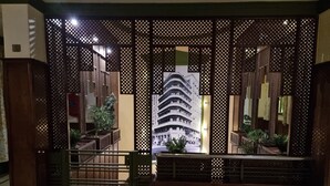 A traditional wooden gate with a view of a modern building through a lattice screen. - Carlton Downtown Cairo (Cairo)