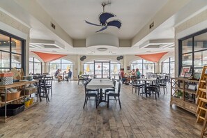 Enjoy meals in this communal dining space with a central table and comfortable seating.
