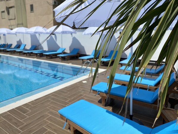 Seasonal outdoor pool, pool umbrellas, pool loungers