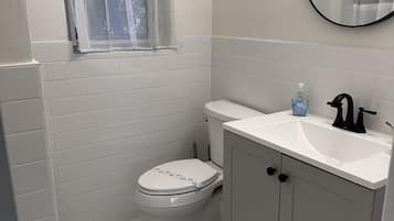 Shower, hair dryer, towels, toilet paper