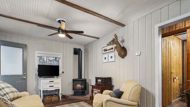 A cozy living room with a fireplace, a television, and a comfortable sofa.