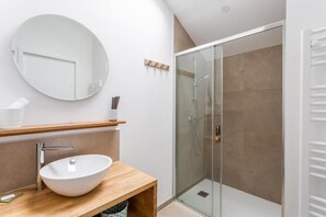 Shower, hair dryer, towels, toilet paper