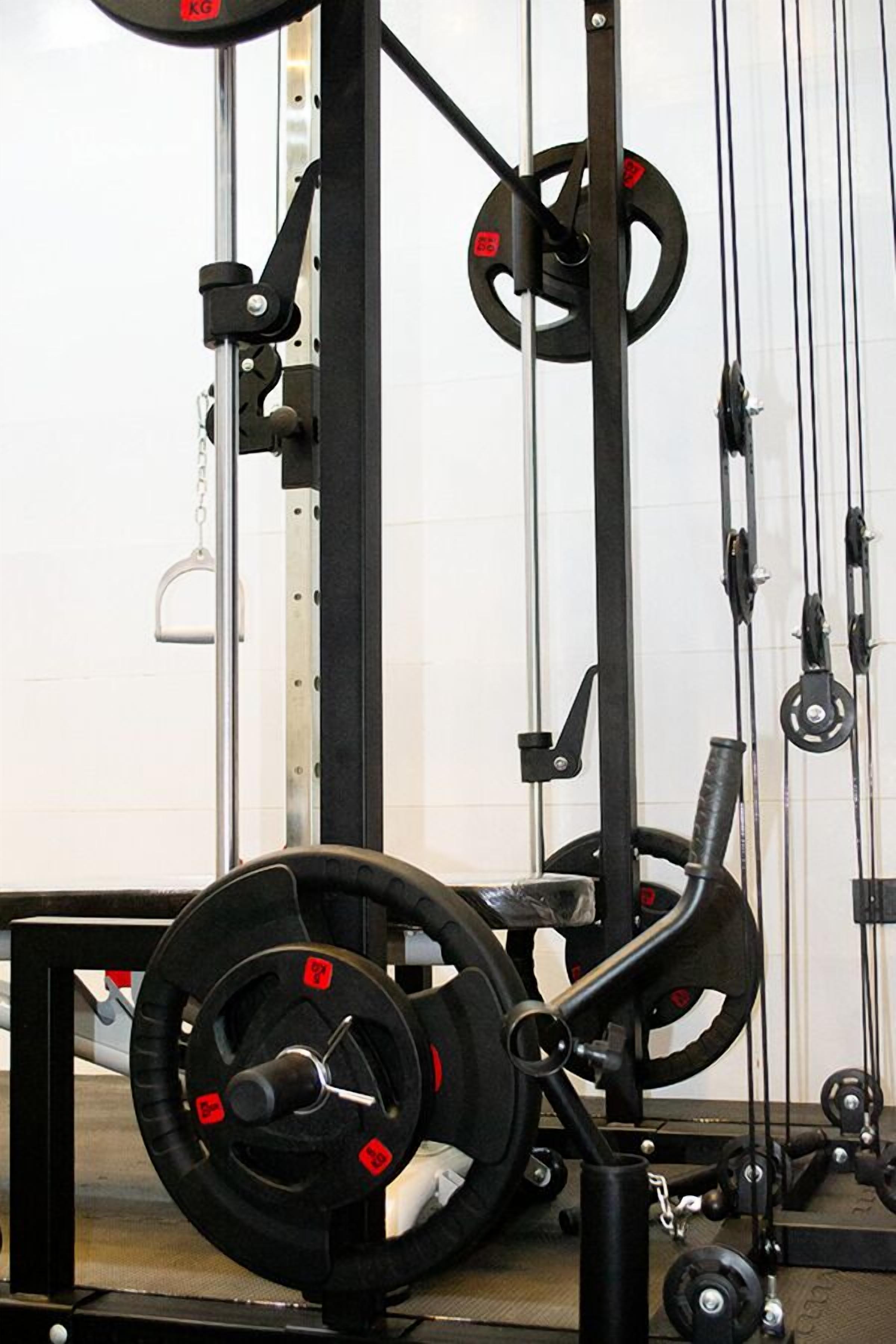 A weightlifting station with a squat rack, barbell, and weight plates.