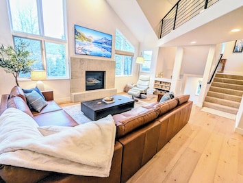 Living Room with gas fireplace, cozy seating, recliner, and 75" Samsung Frame TV