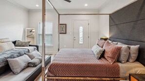 Une chambre à coucher avec un lit à baldaquin, un canapé et une table de chevet.