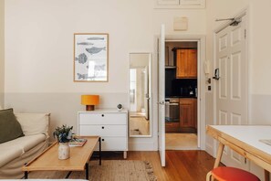 Un espace de vie compact comprenant une kitchenette, un coin repas et un canapé.
