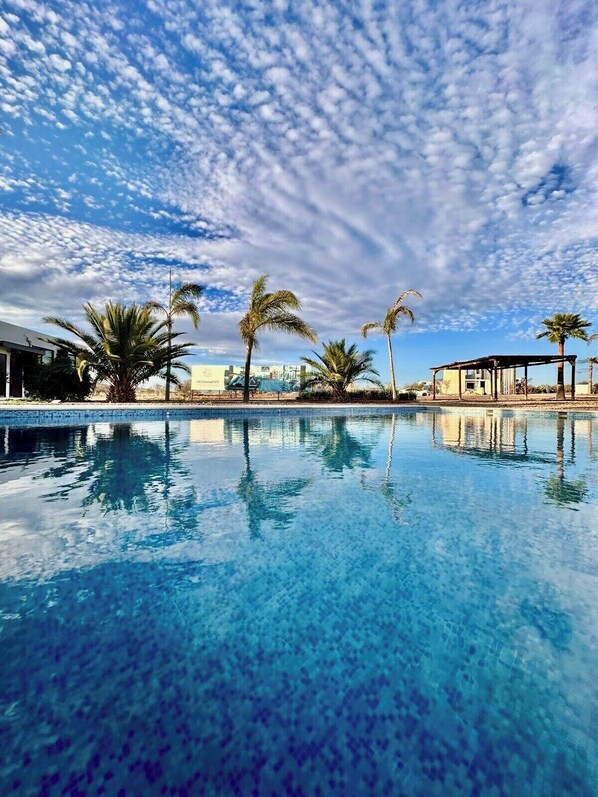 Una piscina al aire libre, una piscina climatizada