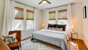 A bedroom with a bed, a chair, a standing lamp, and a ceiling fan. - Walk to Dtwn: 'Tyler Tudor' w/ Backyard (Tyler)