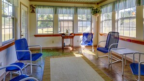 A room with blue chairs, a table, and a rug. - Vintage Chipley Getaway on Large Private Property (Chipley)