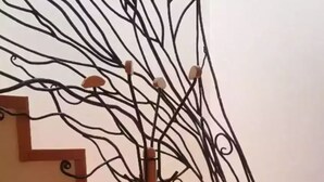 A staircase with a metal railing featuring a complex, abstract design. - ROOFTOP 3BR PH-INDOOR SAUNA IN DUBLIN (Dublin)
