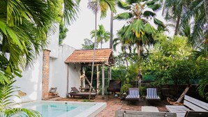 A pool area with a tiled deck, lounge chairs, and a small pavilion. - Hotel CRC-8S Cerca al Mar con Desayuno  (Cartagena)