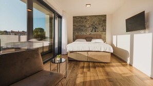 A modern bedroom with a large bed, a sofa, and a small table. - Villa Angelina - Idyllic 4 BD villa for 8 with pool close to Porec (Kaštelir)