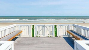 A wooden deck with white railings, benches, and a view of the ocean. - 458 Tarpon Blvd (Fripp Island)