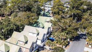 A cluster of houses with green roofs, surrounded by trees and a road. - 37 Davis Love Drive (Fripp Island)