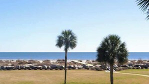A beach view with palm trees and a clear sky. - 126 Capt John Fripp Villa (Fripp Island)