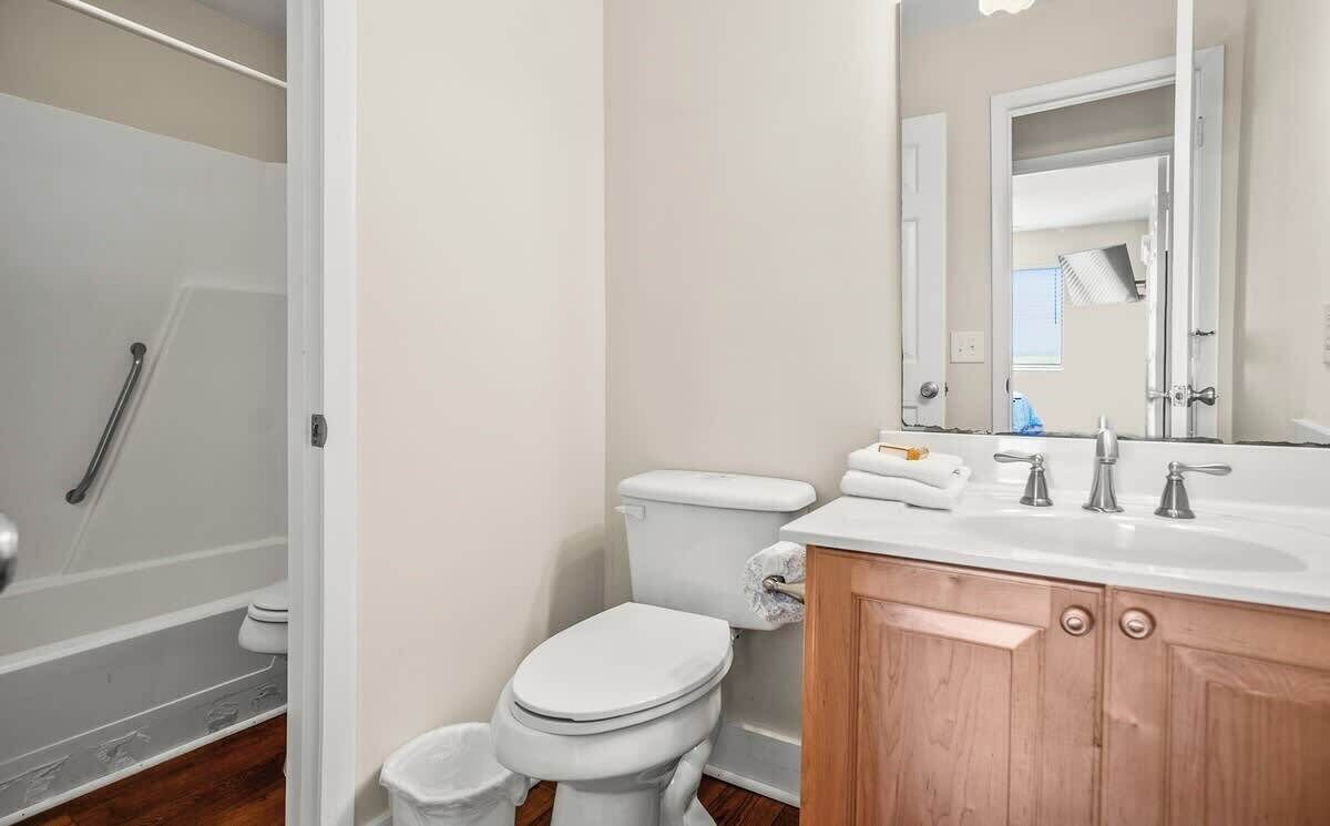 A bathroom with a shower, toilet, and sink.