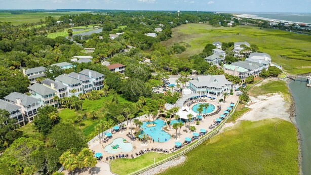 A resort with multiple swimming pools, beachfront areas, and lush greenery. - 271 Deer Lake Drive (Fripp Island)