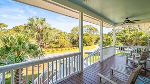 A covered porch with white railings, wooden flooring, and a ceiling fan. - 271 Deer Lake Drive (Fripp Island)