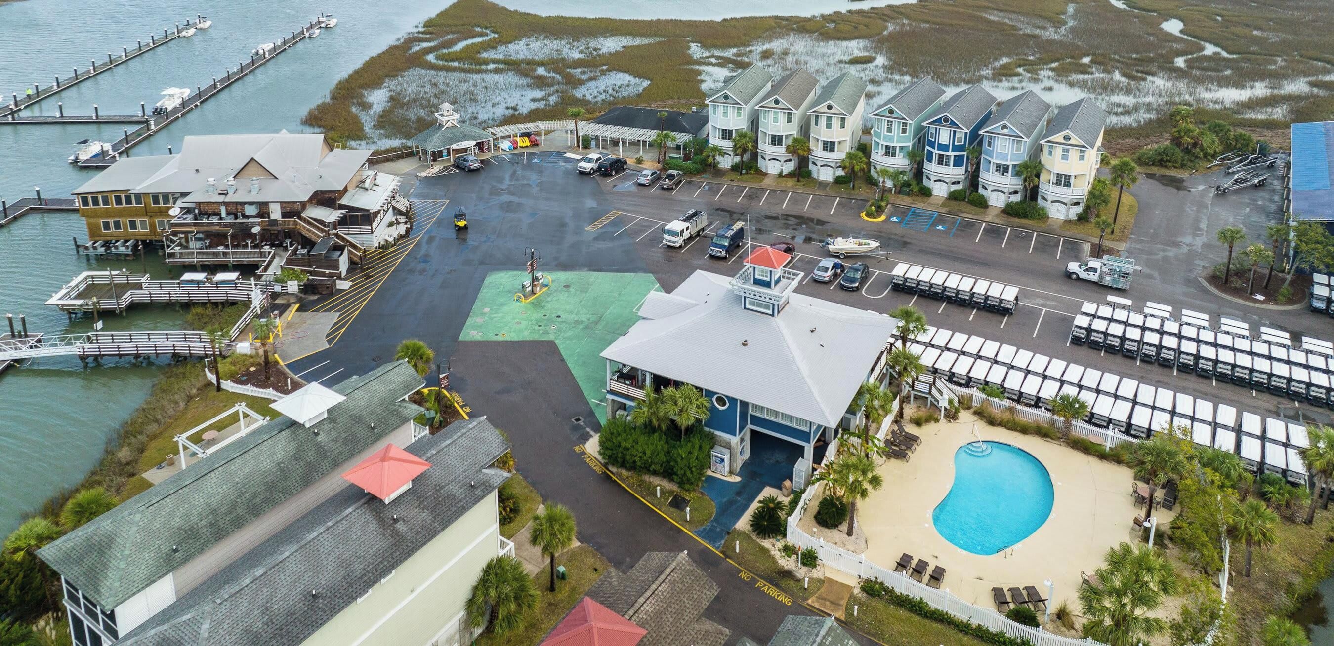 A coastal property with a marina, a swimming pool, and a parking lot.