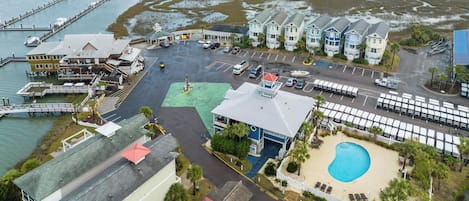A coastal property with a marina, a swimming pool, and a parking lot.