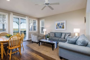 A living room with a dining area, a ceiling fan, and a painting on the wall. - 15 Quarterdeck Lane (Fripp Island)