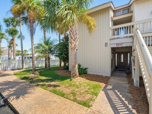 A building with a staircase leading to a door marked '144' and '143'. - 143 Captain John Fripp Villa - The Lone Palm (Fripp Island)