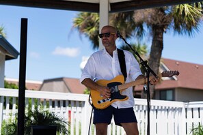 A person playing an electric guitar outdoors. - 143 Captain John Fripp Villa - The Lone Palm (Fripp Island)