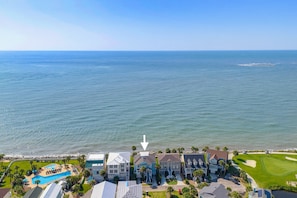 A coastal residential area with a large body of water, a swimming pool, and houses with front yards. - 407 Ocean Point Lane (Fripp Island)