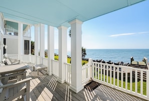 A covered outdoor deck with white railings, a wooden floor, and a view of the ocean. - 407 Ocean Point Lane (Fripp Island)