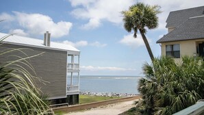 A coastal property with a balcony, a palm tree, and a view of the sea. - 606 Newhaven (Fripp Island)