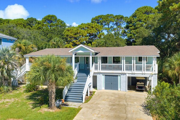 A two-story house with a covered porch and a garage.