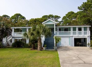 A two-story house with a front porch, a staircase, and a garage.