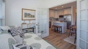 A modern apartment with a living room, kitchen, and dining area. - 619 Porpoise Circle (Fripp Island)