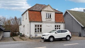 A white building with a red-tiled roof and the name 'SOLBAKKEN' on the front.