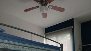 A bunk bed with a ceiling fan, a window with blinds, and a wardrobe. - RELAX AND QUIET PLACE (Q.R.)