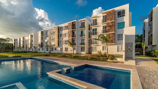 A modern apartment complex with a swimming pool, multiple balconies, and a well-maintained lawn. - RELAX AND QUIET PLACE (Q.R.)