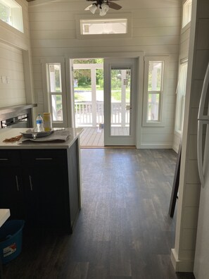 Interior - Park Model TinyHome with spacious front porch table outdoor furniture and spa. (Clubb)