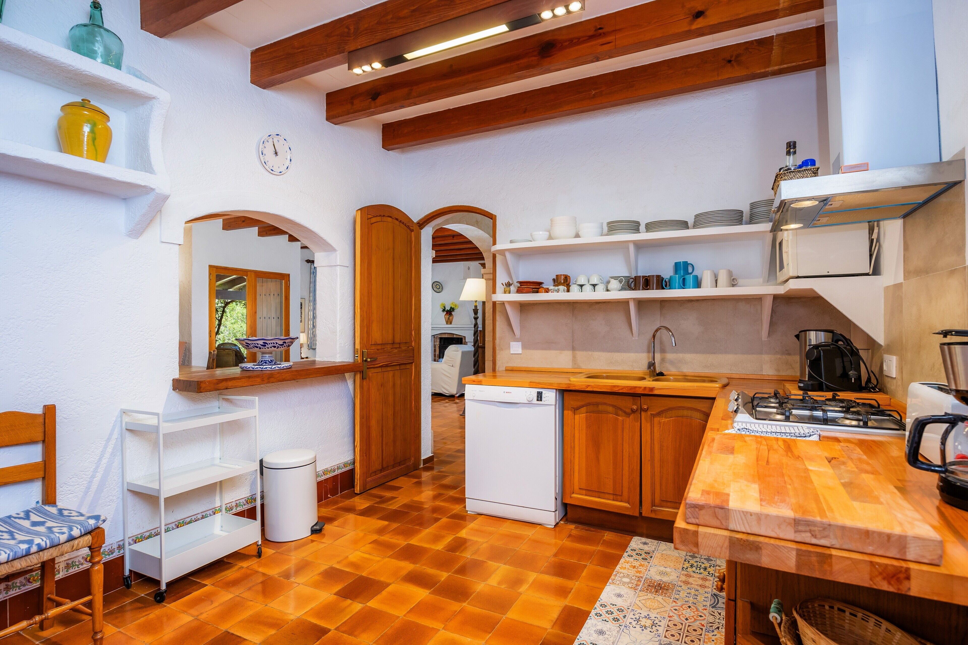 A compact kitchen with wooden cabinets, a built-in oven, and a sink.