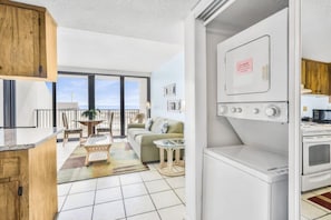 A compact living space with a kitchenette, a dining area, and a sofa.